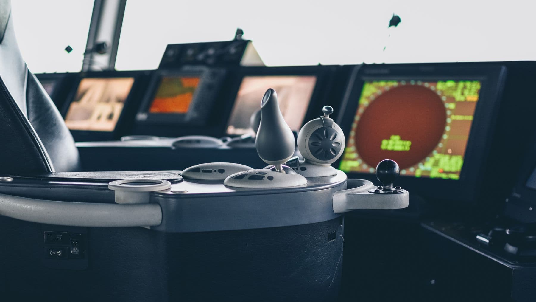 Close-up view of ship navigation controls and radar screens, capturing maritime technology.